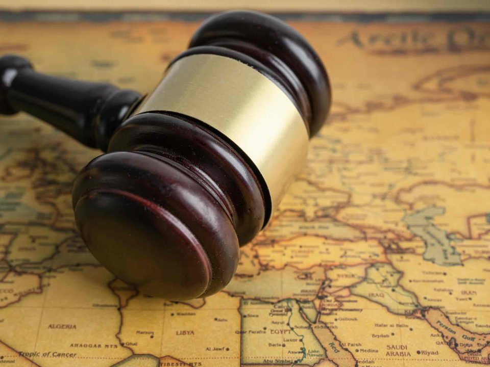 Judge's gavel resting on an antique world map